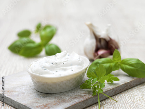 Creamy garlic and herb soft cheese in serving dish