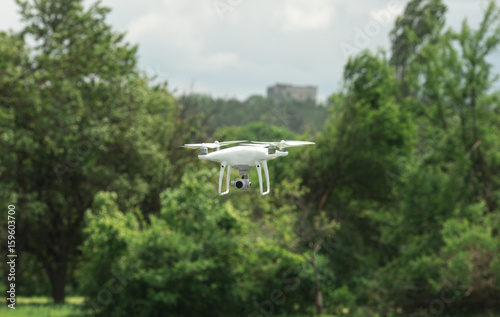 Closeup shot of a small drone flying above green lawn