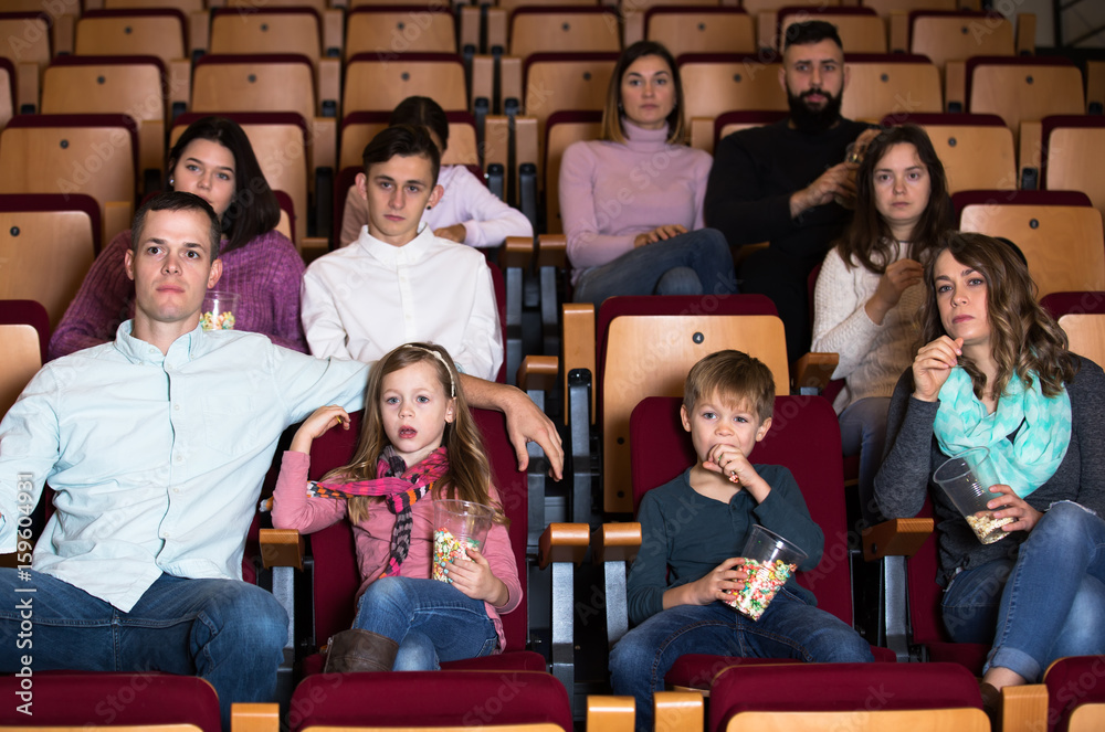 Fototapeta premium People eating popcorn in cinema