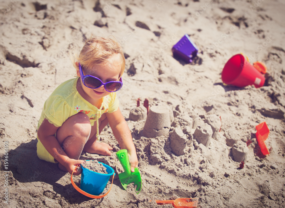 cute little girl play with sand on beach cute little girl play with sand on beach