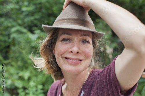 Portrait of confident woman wearing a trilby in forest photo