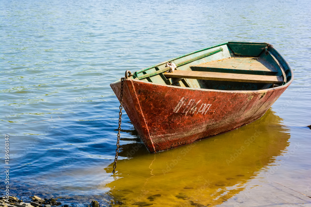 Red boat moored on the river in summer Red boat moored on the river in summer