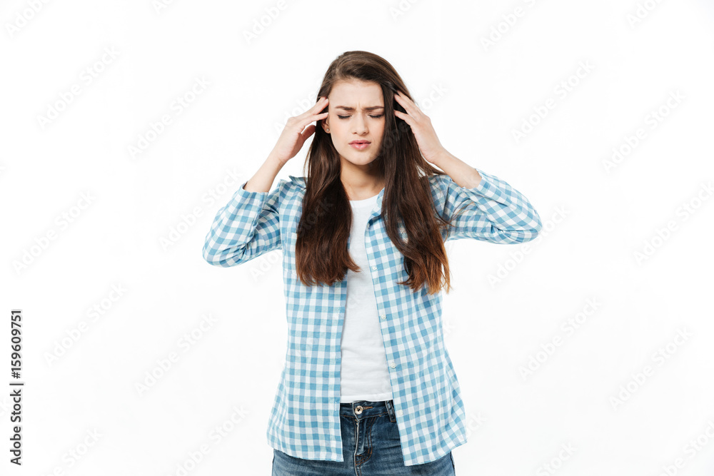 Portrait of a young casual woman suffering from migraine Portrait of a young casual woman suffering from migraine