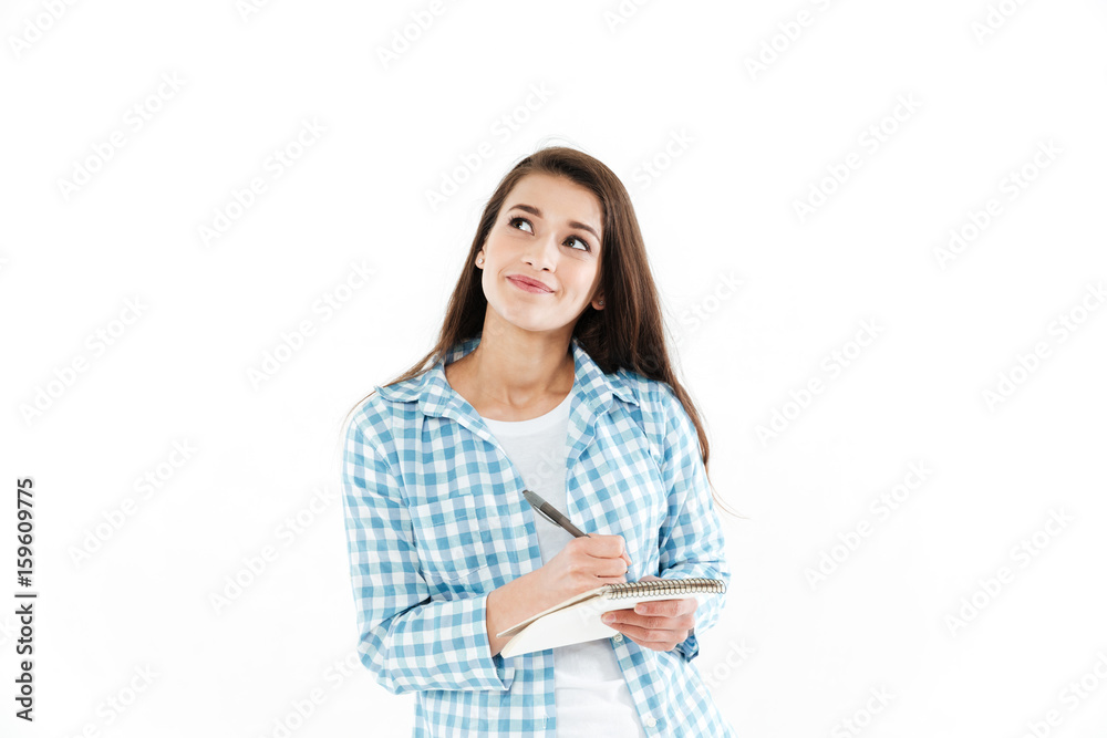 Portrait of a pensive pretty woman making notes Portrait of a pensive pretty woman making notes