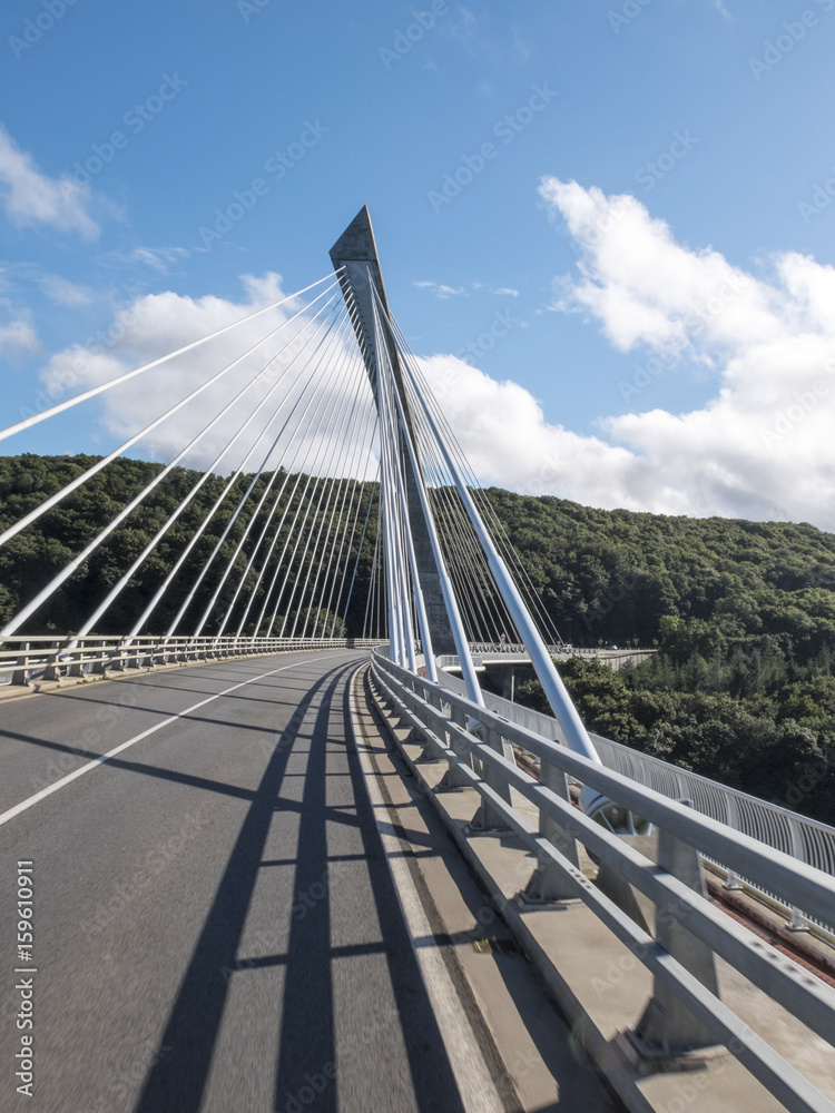 Modern concrete bridge suspended on the river Aulne in Brittany on a sunny summer day.