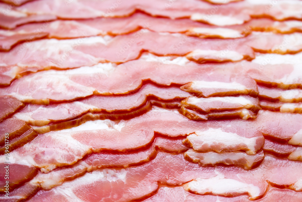 Close-up, background of raw bacon, a popular meat product, ingredient of many dishes. Close-up, background of raw bacon, a popular meat product, ingredient of many dishes.