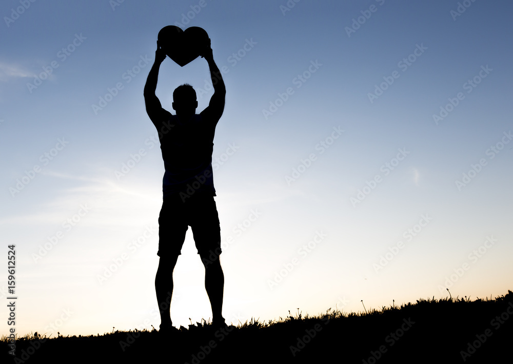 men hands holding hearts silhouette on Silhouette sunset