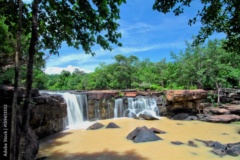 Turbid water stream in early rainy season at Tat Ton Waterfall during sunny day with blue sky, Tat Ton National park, Chaiyaphum province, Thailand Turbid water stream in early rainy season at Tat Ton Waterfall during sunny day with blue sky, Tat Ton National park, Chaiyaphum province, Thailand