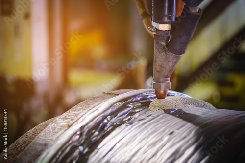 Submerged arc welding process in steel industry.