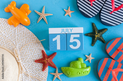 July 15th. Image of july 15 calendar with summer beach accessories and traveler outfit on background. Summer day, Vacation concept