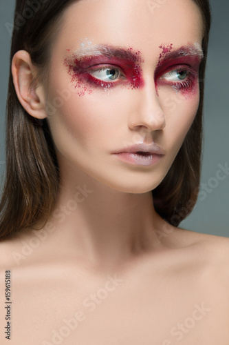 Beautiful woman face portrait close up with red make up
