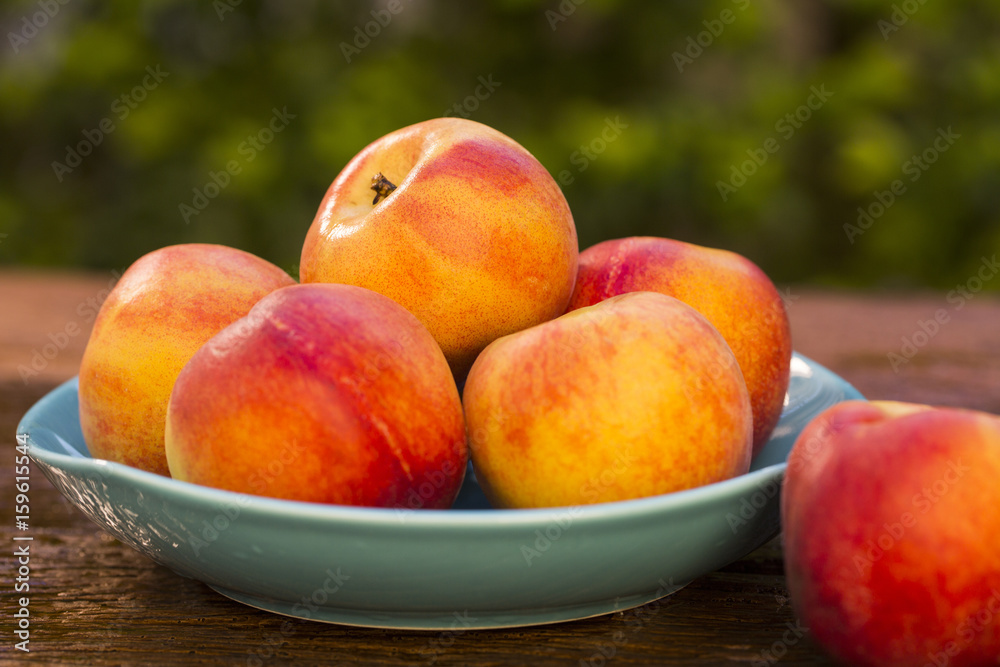 Nectarines on wooden table.