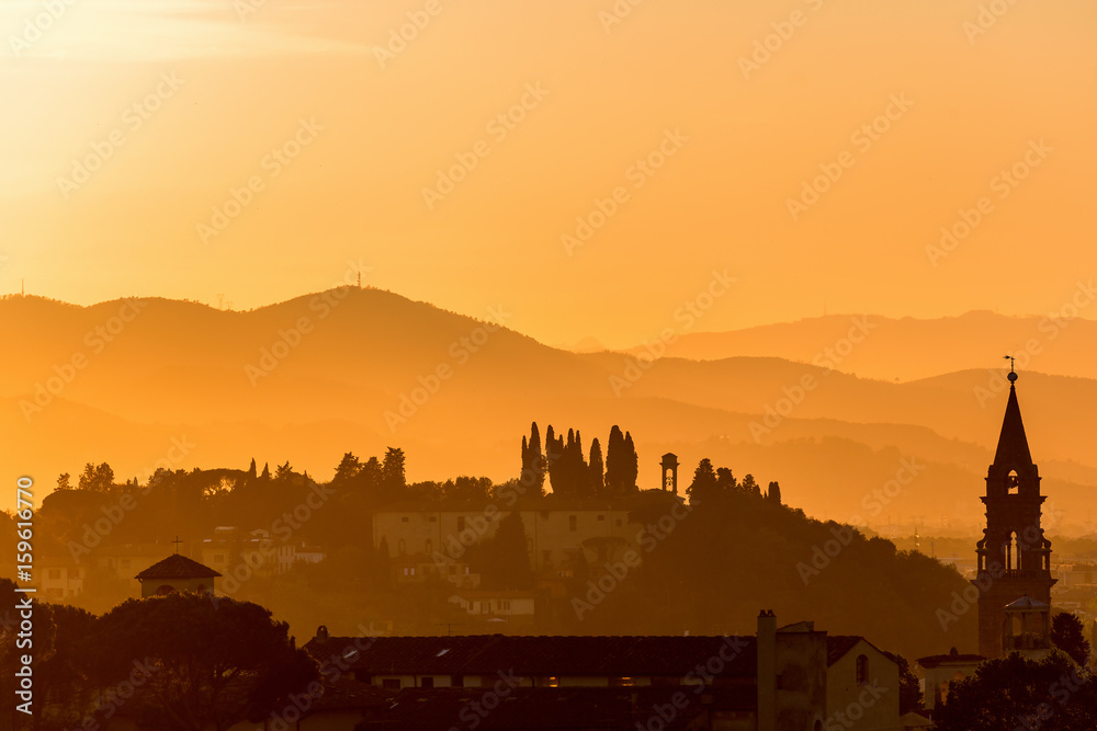 Sunset with houses on hills