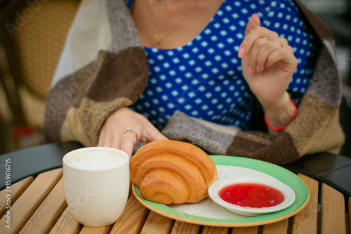 Jam a croissant and coffee. French breakfast on the terrace in a cozy cafe