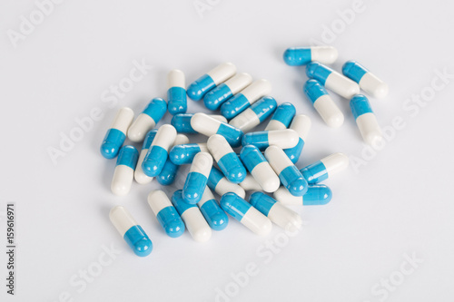 Closeup of medical blue pills on the white background.
