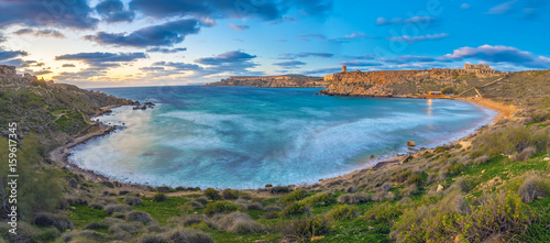 Mgarr  Malta - Panoramic skyline view of the famous Ghajn Tuffieha bay at blue hour on a long exposure shot with beautiful sky and clouds