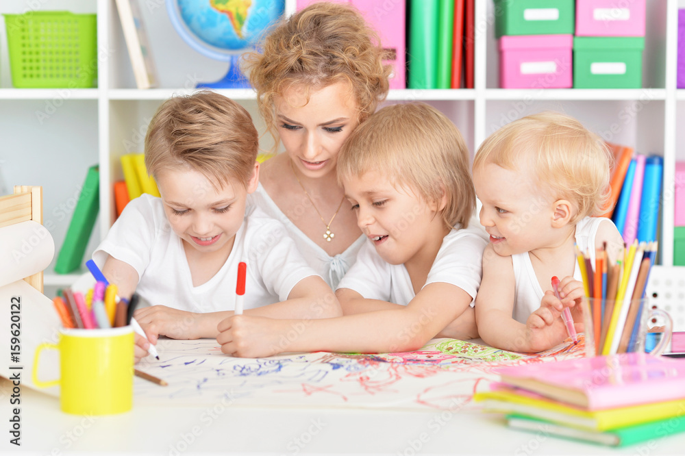 Mother drawing with three cute sons Mother drawing with three cute sons
