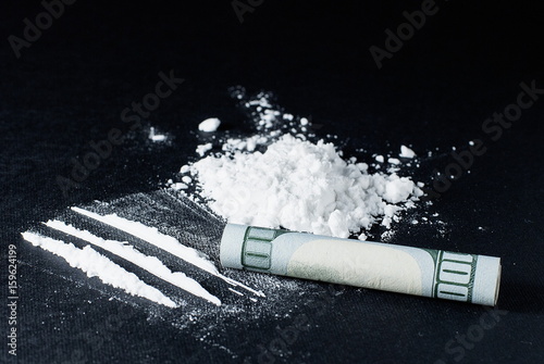 Cocaine divided into paths on a black background