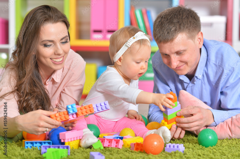 Happy parents playing with little daughter Happy parents playing with little daughter