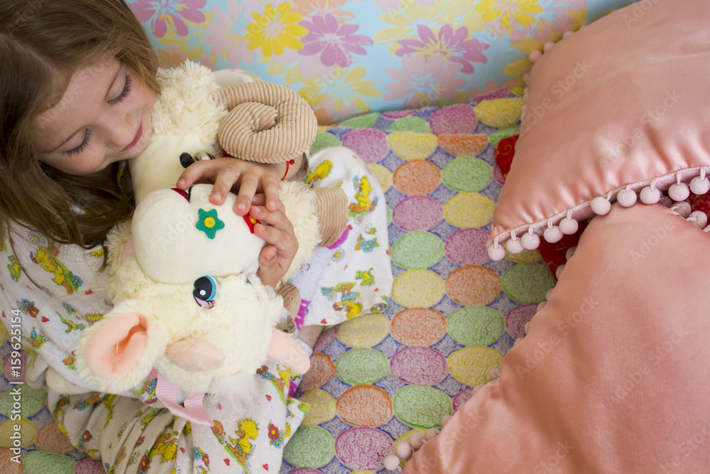 Little girl in bed hugging no-name teddy bear Little girl in bed hugging no-name teddy bear