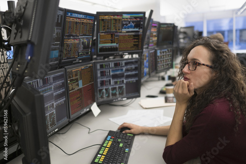 Young woman analyzing computer data photo