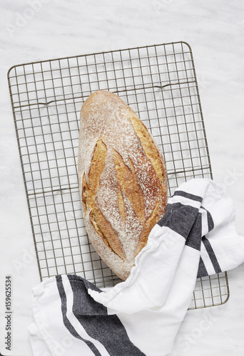 Overhead view of fresh rye bread and dishcloth