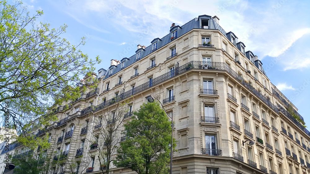 Facade of typical building with attic in Paris