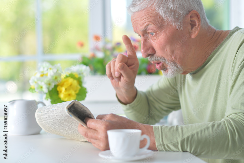 Beautiful old man reading a newspaper Beautiful old man reading a newspaper