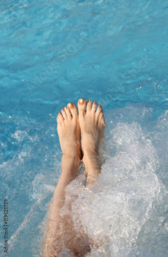 Woman barefoot in the spa pool during a hydromassage session the