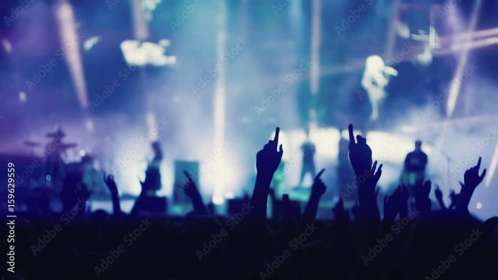 Iconic night rock concert front row crowd cheering hands in air slomo 100p