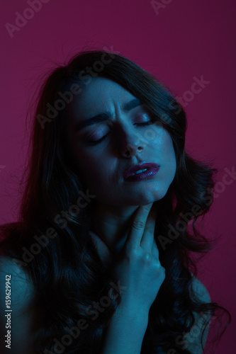 Woman feeling throat ache at night