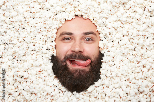 Man with tongue out in popcorn