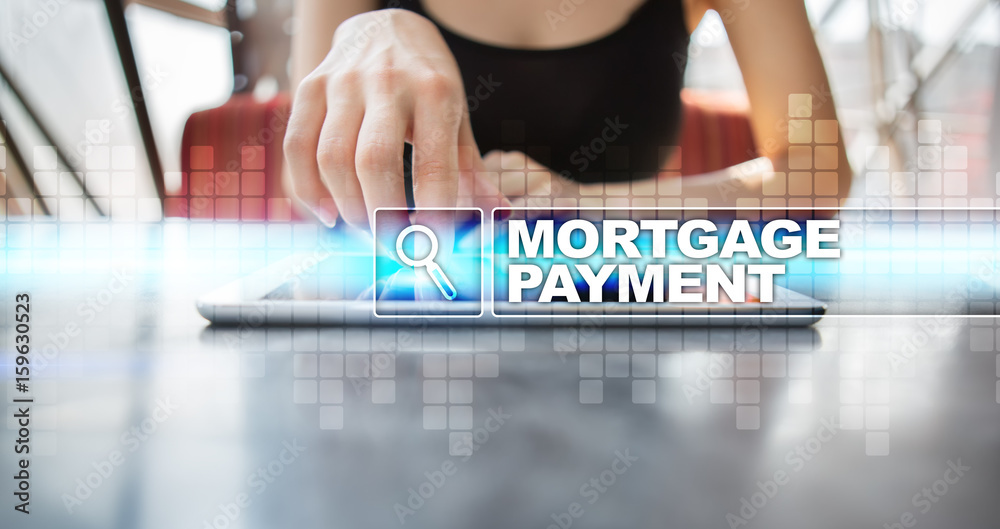 Woman using tablet pc and selecting mortgage payment.