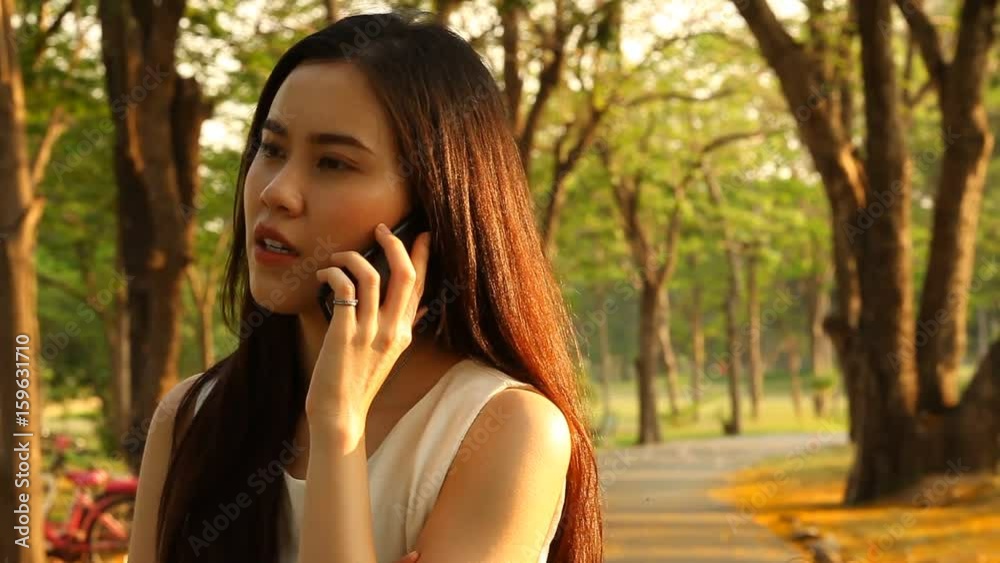 Thai pretty woman talkative with smartphone Thai pretty woman talkative with smartphone