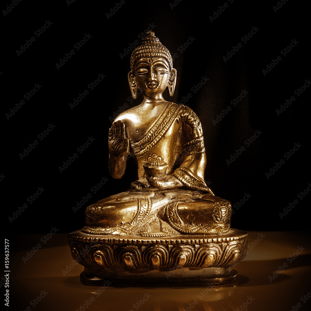 A bronze Buddha statue, a symbol of Buddhism A bronze Buddha statue, a symbol of Buddhism