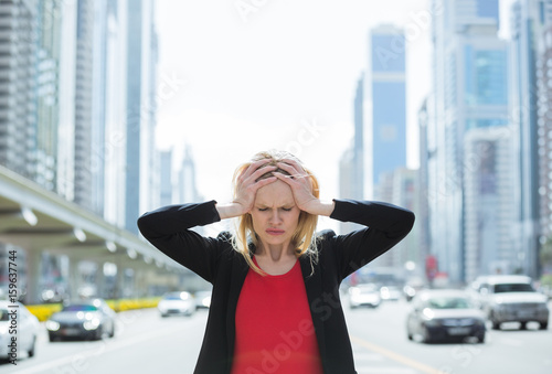 Stressed business woman in the busy city.
