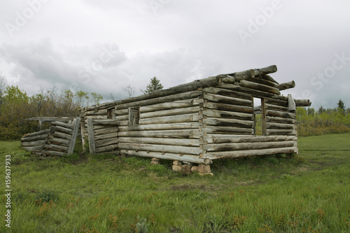Abandoned and delapidated log cabin in rural setting