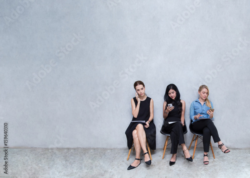 Business groups to using phones. During the wait for the interview at modern office, with copy space