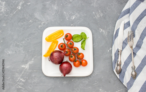 Vegetable concept flat lay with cherry tomatoes, basil,pepper and onoin. Top view photo