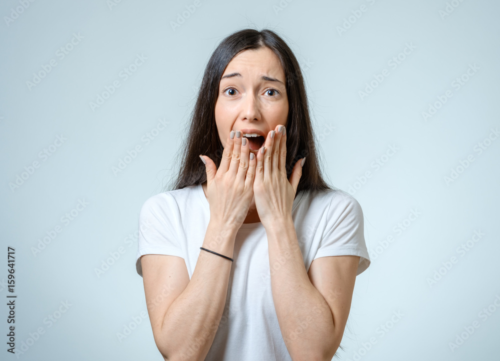 Beautiful young woman with a fear expression Beautiful young woman with a fear expression