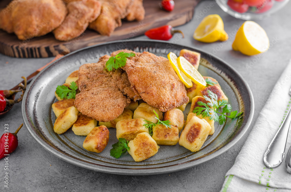 Schnitzel original with lemon and gnocchi fried Schnitzel original with lemon and gnocchi fried