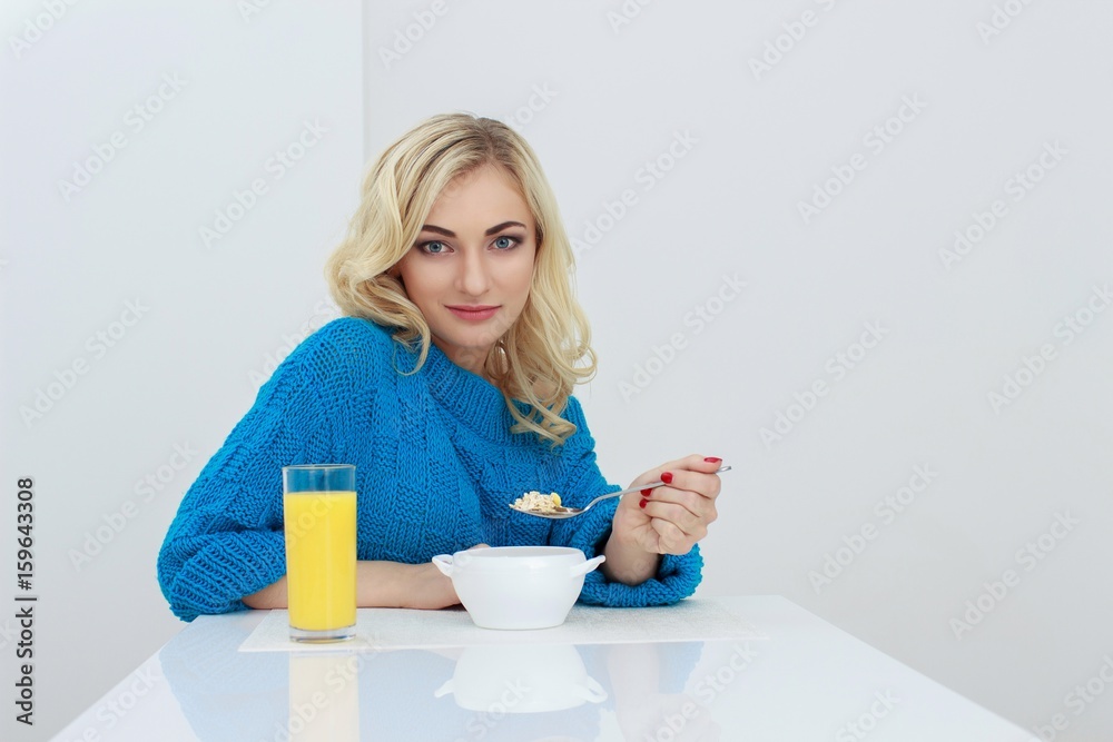 Wellness concept. Beautiful young woman having breakfast and smiling. Healthy eating. Dieting concept. Wellness concept. Beautiful young woman having breakfast and smiling. Healthy eating. Dieting concept.