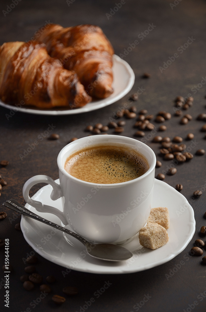 Cup of fresh coffee with croissants on dark background, selective focus Cup of fresh coffee with croissants on dark background, selective focus