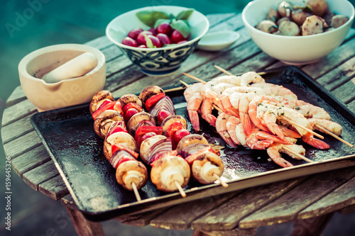 barbecue in the garden - summer- prawns and vegetables on skewers
