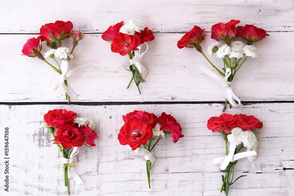 Red roses small bouquets on white background 