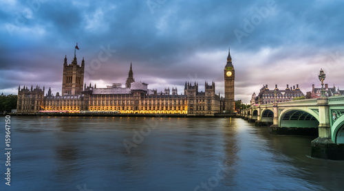 View of the Houses of Parliament and Westminster Bridge in London at sunset © offcaania