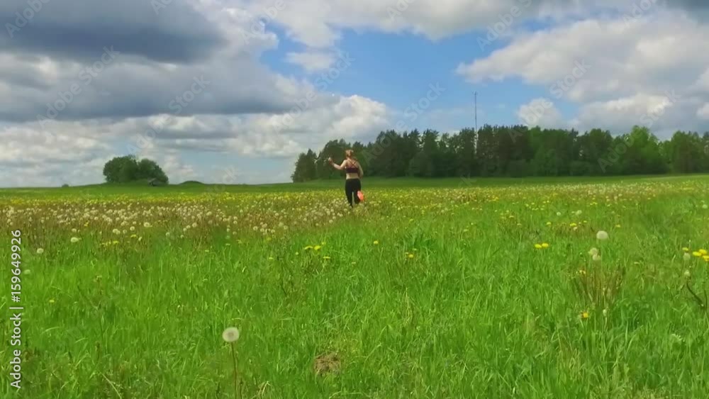Girl hiker running on beautiful field. Steadicam shot. Slow motion footage. Girl hiker running on beautiful field. Steadicam shot. Slow motion footage.