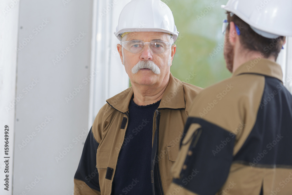 two builders having a conversation two builders having a conversation