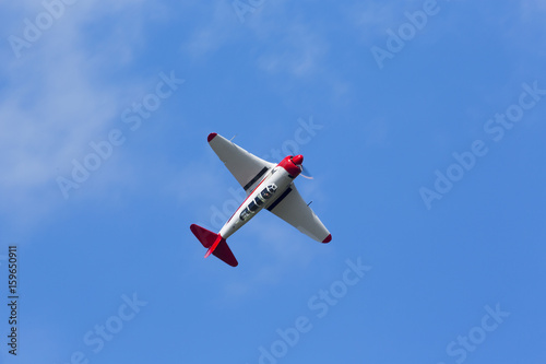 Historical airplane doing manoeuvres in the sky. Veteran pilot with a veteran plane against a blue sky. Copy space.