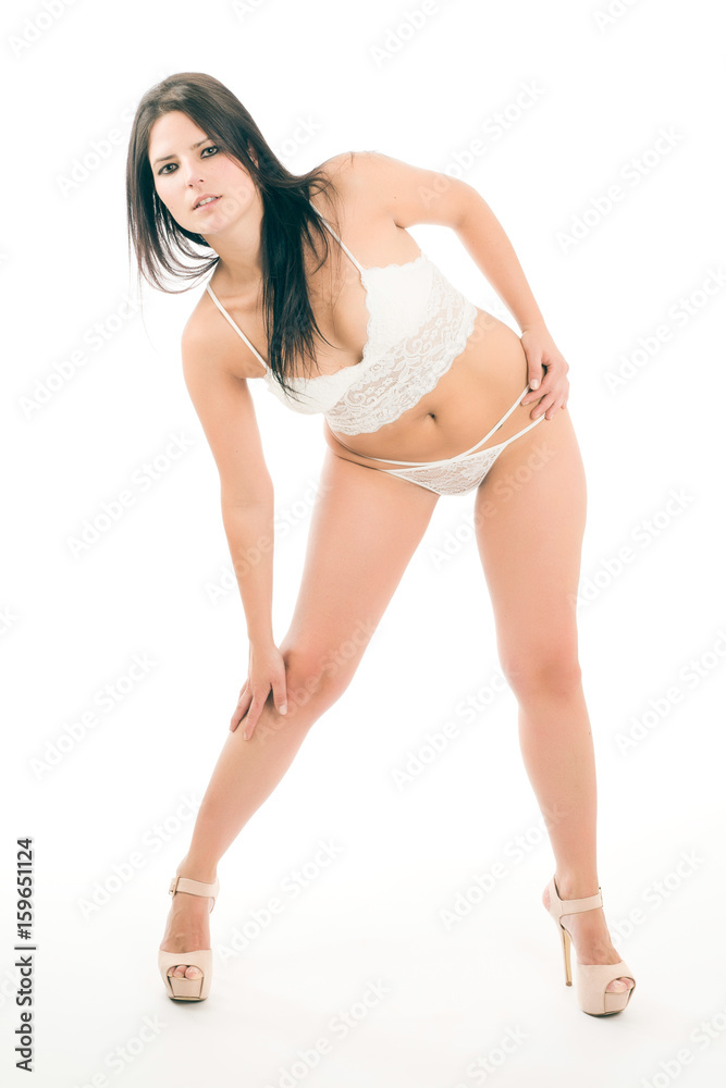 Young woman poses in white lingerie on white background Young woman poses in white lingerie on white background